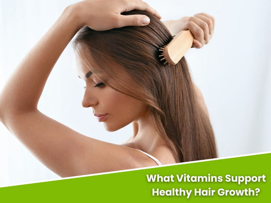 Woman brushing long brown hair, exploring hair growth vitamins for healthier, stronger hair.