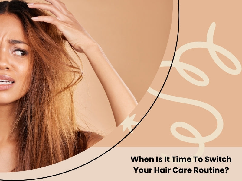Woman examining dry, damaged hair, questioning if it's time to change her hair care routine.