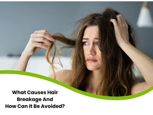 Distressed woman examining damaged hair strands, illustrating hair breakage causes and prevention tips.